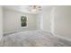 This bedroom is spacious and bright, featuring light-colored walls, tile flooring, and a ceiling fan at 266 Buford Ave, Orange City, FL 32763
