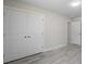 Bright bedroom features wood-look tile flooring and a large closet with double doors at 266 Buford Ave, Orange City, FL 32763