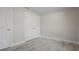 Bright bedroom features wood-look tile flooring, white trim and a closet with double doors at 266 Buford Ave, Orange City, FL 32763