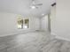 Bright bedroom features natural light, ceiling fan, and neutral paint with beautiful tile floor at 266 Buford Ave, Orange City, FL 32763