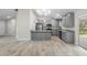 Modern kitchen featuring stainless steel appliances, gray cabinetry, and gorgeous tile floors in open concept at 266 Buford Ave, Orange City, FL 32763