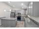 Bright kitchen features shaker cabinets, stainless appliances, granite countertops, and a center island at 266 Buford Ave, Orange City, FL 32763