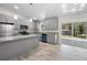 Modern kitchen featuring grey cabinets, granite countertops, stainless steel appliances, and sliding glass door at 266 Buford Ave, Orange City, FL 32763