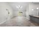 Open-concept kitchen and living room featuring modern lighting, and gorgeous tile floors at 266 Buford Ave, Orange City, FL 32763