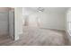 Spacious living room featuring vaulted ceiling, ceiling fan and neutral paint with beautiful tile floor at 266 Buford Ave, Orange City, FL 32763
