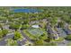 Beautiful aerial view of complex featuring pool, tennis courts, landscaping, and nearby lake at 2704 Lancaster Ct, Apopka, FL 32703