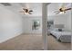 Bedroom view to another bedroom with carpet, modern lighting, neutral paint, and views from each window at 2704 Lancaster Ct, Apopka, FL 32703