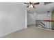Hallway featuring carpet, neutral paint, a railing to stairs, and several doors to rooms at 2704 Lancaster Ct, Apopka, FL 32703