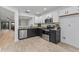 Updated kitchen showcasing stainless appliances, granite countertops and view to living room at 2704 Lancaster Ct, Apopka, FL 32703