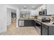 Updated kitchen featuring stainless appliances, granite countertops and black cabinets at 2704 Lancaster Ct, Apopka, FL 32703