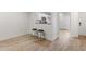 Cozy kitchen and breakfast bar area with tile floors and white cabinets at 2704 Lancaster Ct, Apopka, FL 32703