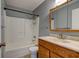 Bathroom featuring shower, a wood cabinet vanity, and mirrored medicine cabinet at 2706 Oak Trail Run # 6, Port Orange, FL 32127