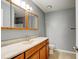 Bathroom featuring a wood cabinet vanity, marble-look counter, and mirrored medicine cabinet at 2706 Oak Trail Run # 6, Port Orange, FL 32127