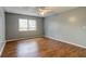 Bright bedroom features wood-look floors, a ceiling fan, and a window at 2706 Oak Trail Run # 6, Port Orange, FL 32127