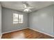 Bedroom with ceiling fan, window letting in natural light, and wood-look floors at 2706 Oak Trail Run # 6, Port Orange, FL 32127