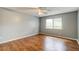 Bright bedroom features wood-look floors, a ceiling fan, and a window at 2706 Oak Trail Run # 6, Port Orange, FL 32127