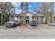Condominium building featuring multiple units, mature landscaping, and ample parking on a sunny day at 2706 Oak Trail Run # 6, Port Orange, FL 32127