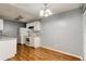 Functional kitchen with white appliances and wood floors, adjacent to a dining area at 2706 Oak Trail Run # 6, Port Orange, FL 32127