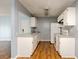 Efficient kitchen with white cabinetry, appliances, and wood floors, open to other living spaces at 2706 Oak Trail Run # 6, Port Orange, FL 32127