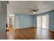 Inviting living room with wood floors, a ceiling fan, and sliding glass doors at 2706 Oak Trail Run # 6, Port Orange, FL 32127