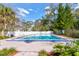 Outdoor swimming pool with lounge chairs and lush landscaping around the gated perimeter at 2706 Oak Trail Run # 6, Port Orange, FL 32127