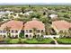 Aerial view of two-story condos with balconies and lush greenery, offering a serene and luxurious living experience at 2982 S Atlantic Ave, New Smyrna Beach, FL 32169
