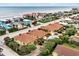 Charming condos with red tile roofs close to the beach, complemented by a shared pool and lush vegetation at 2982 S Atlantic Ave, New Smyrna Beach, FL 32169