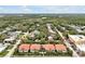 A scenic aerial view of a charming neighborhood featuring lush greenery and colorful homes at 2982 S Atlantic Ave, New Smyrna Beach, FL 32169