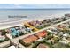 An aerial view of houses near the beach, a beach entrance is noted at 2982 S Atlantic Ave, New Smyrna Beach, FL 32169