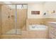 Luxurious bathroom with glass enclosed shower, soaking tub, and tile surround at 2982 S Atlantic Ave, New Smyrna Beach, FL 32169