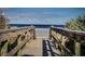 Beach access point on a wooden boardwalk through lush greenery to ocean at 2982 S Atlantic Ave, New Smyrna Beach, FL 32169