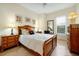Inviting bedroom with a wooden bed, neutral walls, and ample natural light from a window at 2982 S Atlantic Ave, New Smyrna Beach, FL 32169