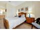 Cozy bedroom featuring a wood bed frame, side tables, and nautical themed artwork at 2982 S Atlantic Ave, New Smyrna Beach, FL 32169