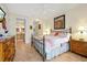 Warm bedroom features an iron bed frame, flamingo bedding, and connected bathroom at 2982 S Atlantic Ave, New Smyrna Beach, FL 32169