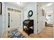 Bright foyer with a decorative rug, roll-top desk, and an open doorway to the bedroom at 2982 S Atlantic Ave, New Smyrna Beach, FL 32169