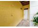 Inviting covered entry with outdoor shower and stone tile flooring, leading to a bright white front door at 2982 S Atlantic Ave, New Smyrna Beach, FL 32169