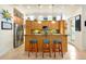 Bright kitchen with granite counters, stainless steel appliances, and decorative barstools at 2982 S Atlantic Ave, New Smyrna Beach, FL 32169