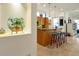 Bright kitchen with tiled floors, granite counters, and decorative barstools with island at 2982 S Atlantic Ave, New Smyrna Beach, FL 32169