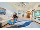 Bright living room featuring an open floor plan, dining area, and a blue-toned accent rug at 2982 S Atlantic Ave, New Smyrna Beach, FL 32169
