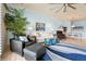 Cozy living room with tile floors, large plant, rug and neutral furniture near dining space at 2982 S Atlantic Ave, New Smyrna Beach, FL 32169