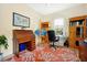Charming home office with hardwood furniture, coral patterned rug, and bright natural light at 2982 S Atlantic Ave, New Smyrna Beach, FL 32169
