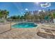 Relaxing community pool area featuring lounge chairs and mature landscaping under a bright sunny sky at 2982 S Atlantic Ave, New Smyrna Beach, FL 32169