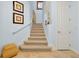 Stairway with carpet runner, light blue walls, and coastal decor for a beachy vibe at 2982 S Atlantic Ave, New Smyrna Beach, FL 32169