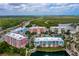 Aerial view of building exteriors with landscaping and waterfront views at 3 Riverwalk Dr # 404, New Smyrna Beach, FL 32169
