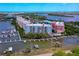 Aerial view of building exterior near waterfront featuring boat docks at 3 Riverwalk Dr # 404, New Smyrna Beach, FL 32169