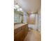 Bathroom featuring granite counters, tiled shower with tub, and vanity lighting at 3 Riverwalk Dr # 404, New Smyrna Beach, FL 32169