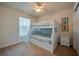 Bedroom featuring a bunk bed, window, and nightstand at 3 Riverwalk Dr # 404, New Smyrna Beach, FL 32169