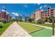 Community bocce court with paver sidewalks, grassy areas, and parking at 3 Riverwalk Dr # 404, New Smyrna Beach, FL 32169