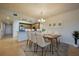 Dining room showcases modern chandelier and furniture, positioned adjacent to the kitchen at 3 Riverwalk Dr # 404, New Smyrna Beach, FL 32169