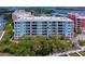 Exterior view of condo building with water views and lush landscaping at 3 Riverwalk Dr # 404, New Smyrna Beach, FL 32169